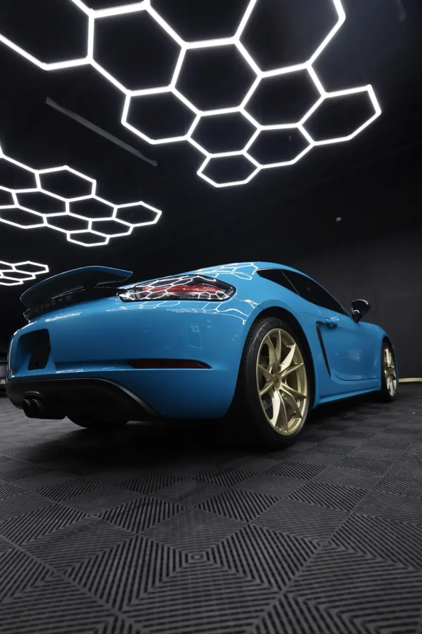 Miami Blue Porsche Cayman rear in the Imperial Auto Lab studio