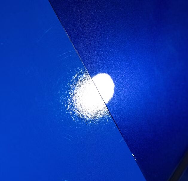 Macro comparison of vinyl wrap texture vs glossy PPF finish